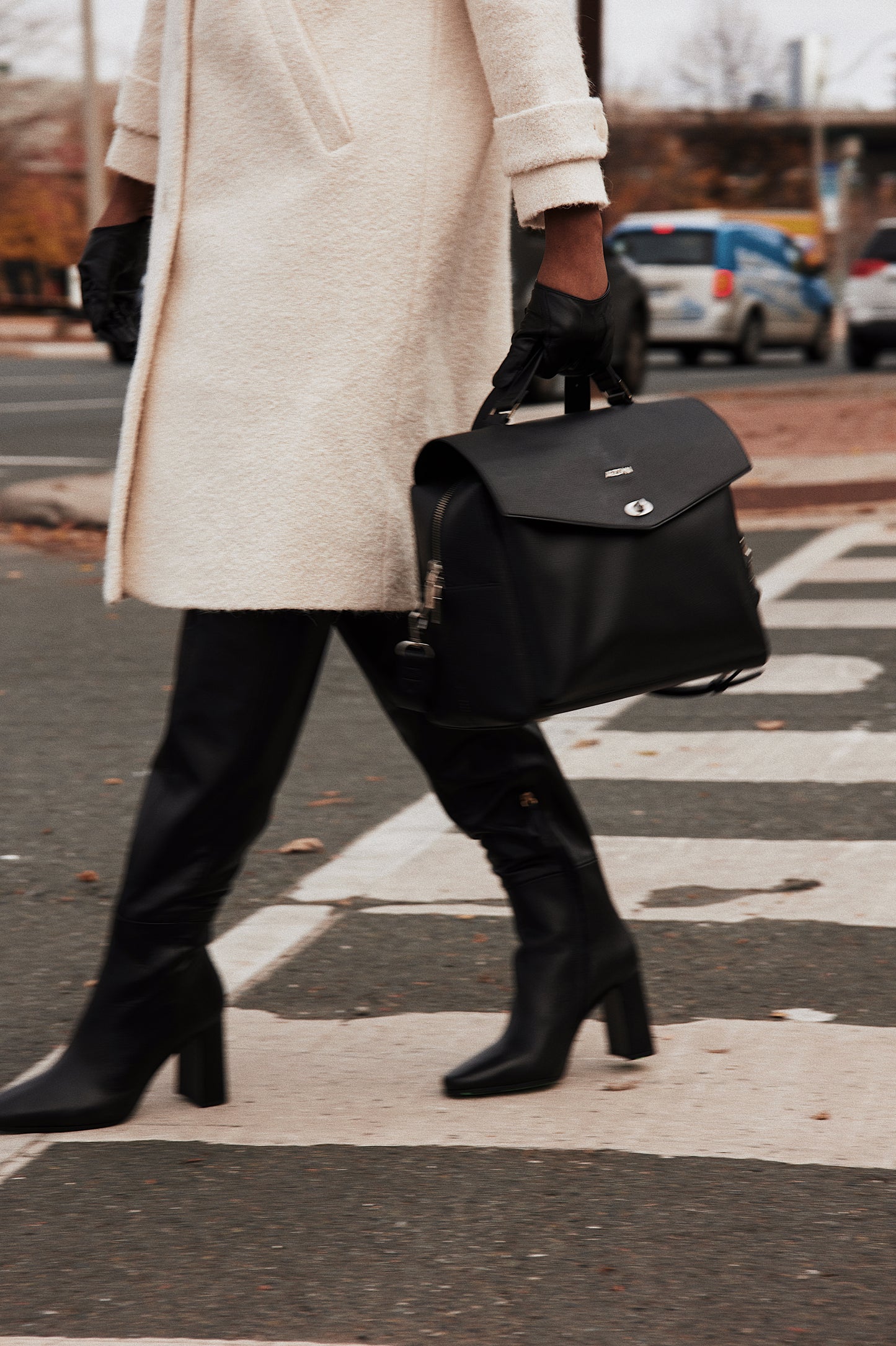 black vegan leather lunch bag wearing carried with work in streets at cross walk