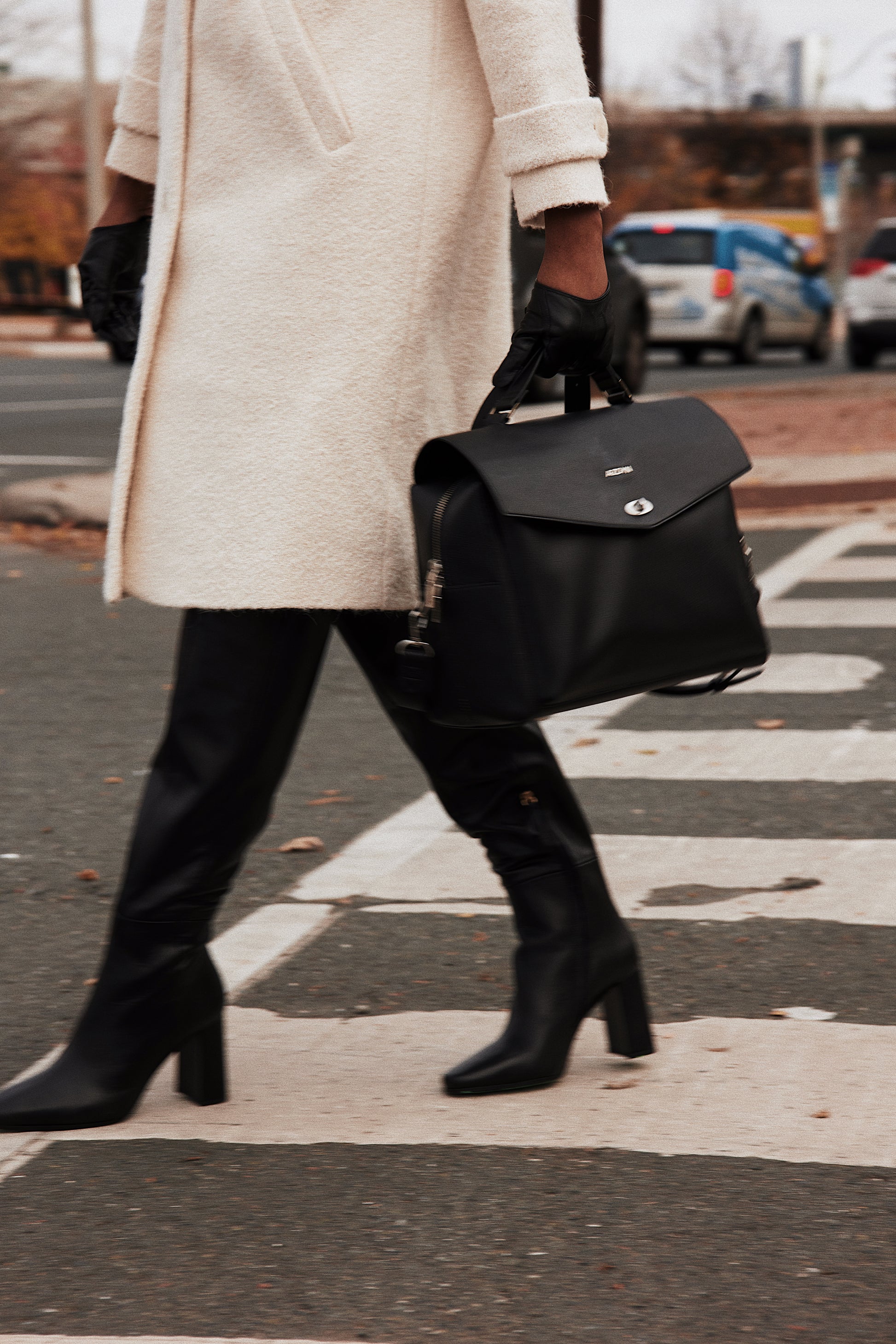 black vegan leather lunch bag wearing carried with work in streets at cross walk